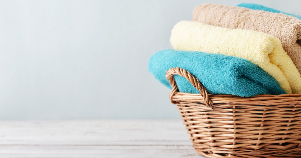 stock-photo--bath-towels-of-different-colors-in-wicker-basket-on-light-background-235139635